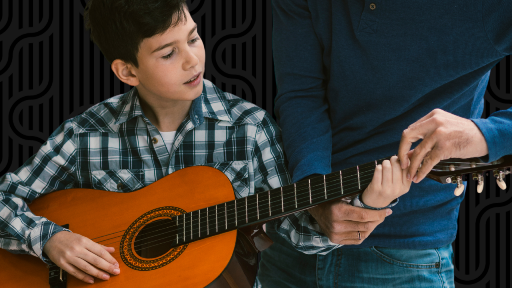child with a smile holding a guitar